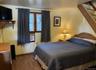 Bedroom with wood finished floors and baseboards