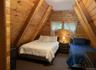 Carpeted bedroom with wooden walls