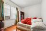 Bedroom featuring wood-type flooring and cooling unit