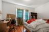 Bedroom with wood-type flooring and a desk