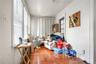 Sitting room with hardwood / wood-style floors and crown molding