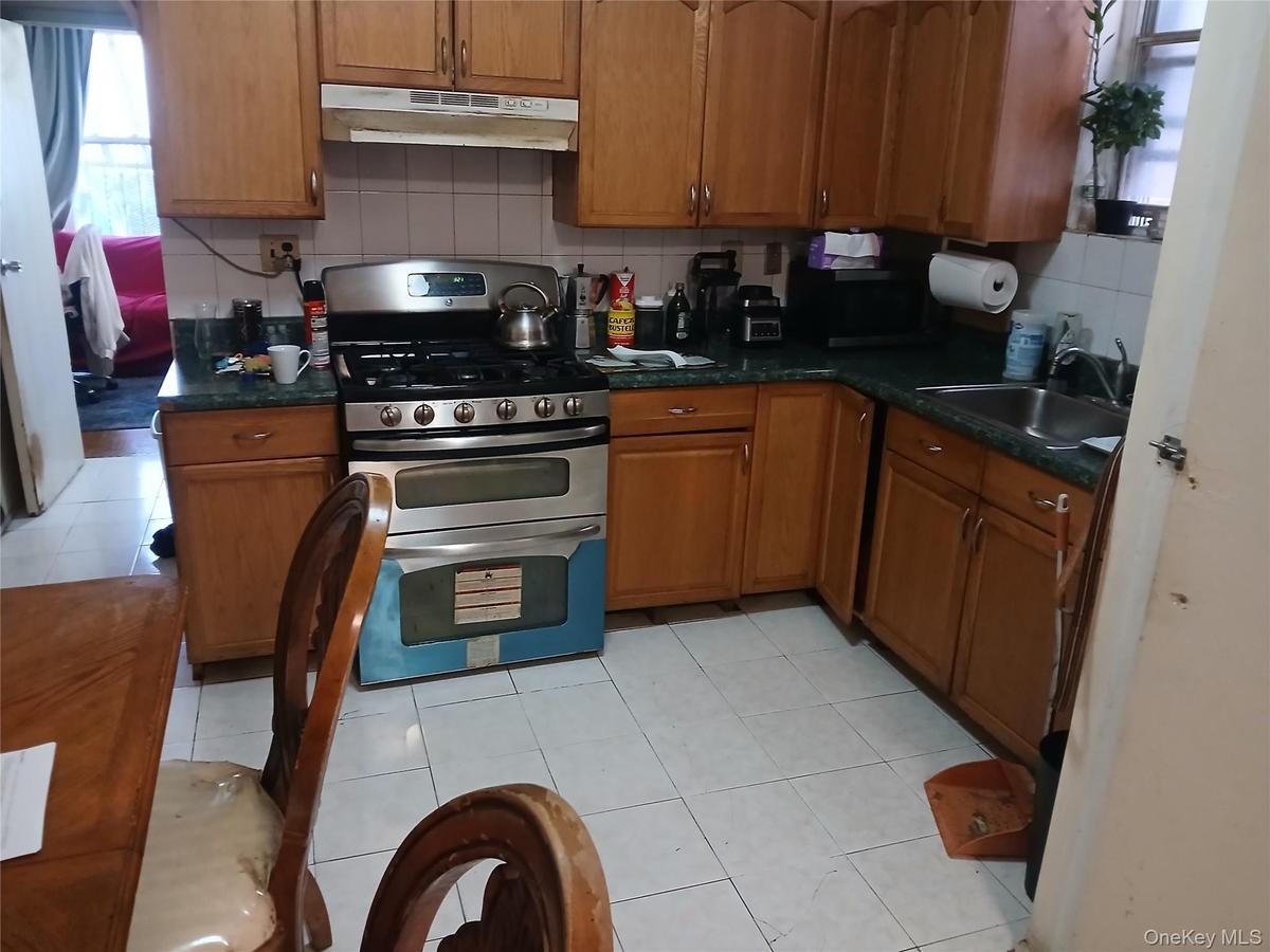 Kitchen with decorative backsplash, double oven range, and brown cabinets