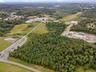 Aerial view of property's location with a forest