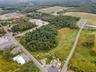 View of property location featuring a forest
