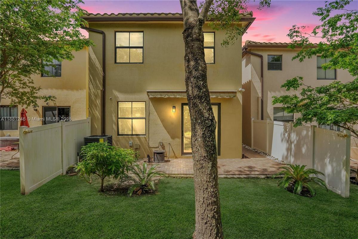 Bright open-concept living with reclining sofas and seamless kitchen access featuring granite and stainless steel.
