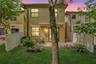 Bright open-concept living with reclining sofas and seamless kitchen access featuring granite and stainless steel.