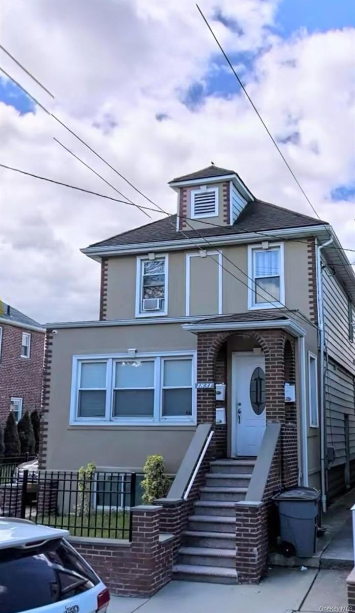 View of front of home with brick siding and stucco siding