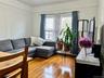 Living room with a baseboard heating unit and hardwood / wood-style floors