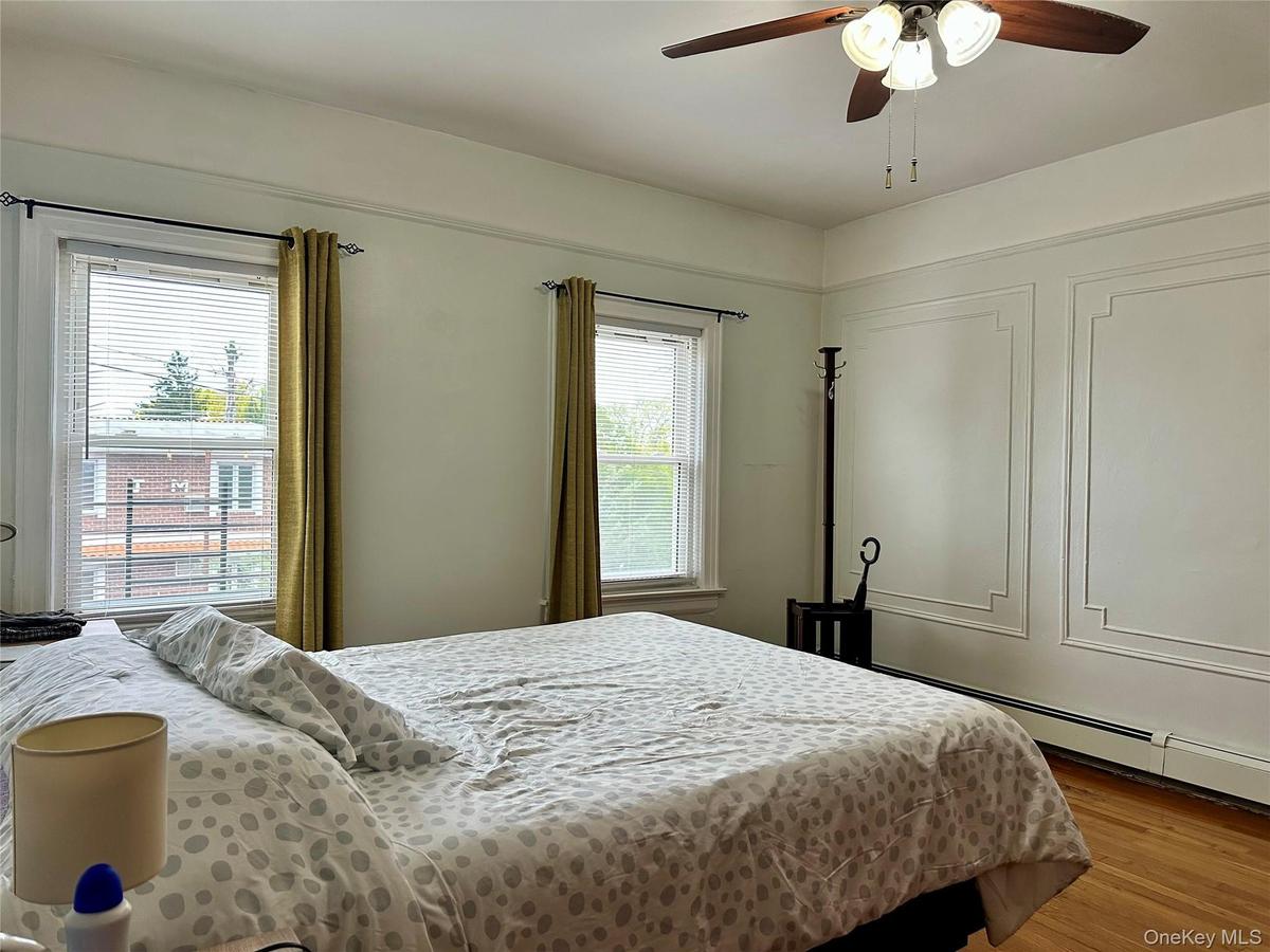 Bedroom with wood finished floors and ceiling fan