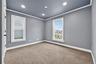 Carpeted bedroom with ornamental molding, plenty of natural light, and recessed lighting