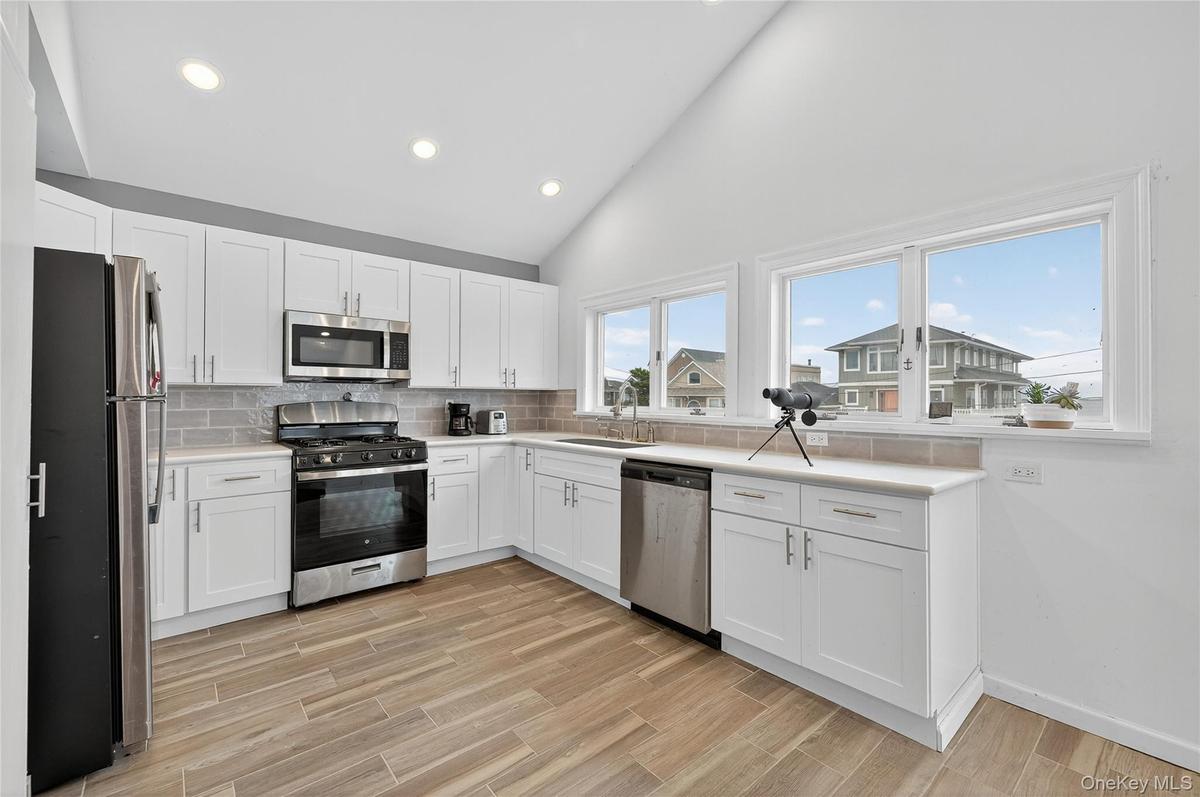 Newly updated kitchen with water view, stainless steel appliances and recessed lighting
