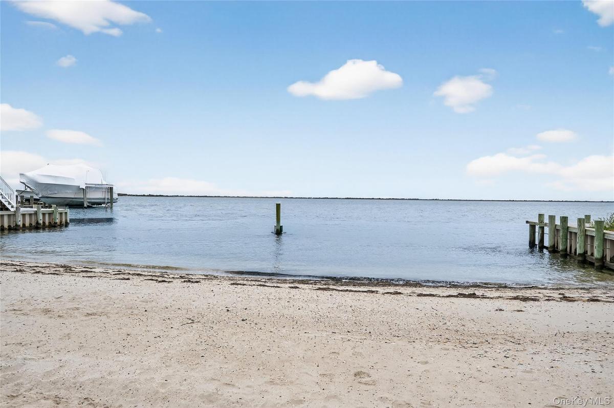 View of water and beach from living area