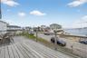 Wooden deck featuring view of Great South Bay and neighborhood