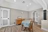 Dining room with arched walkway, wood-type floors, and recessed lighting