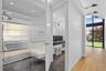 Full bathroom featuring a wall of windows, vanity, a walk in shower, and light wood finished floors