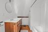 Bathroom featuring shower / bath combo, vanity, and light wood-style flooring