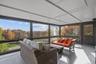 Sunroom / solarium with an outdoor living space, wood-type flooring, plenty of natural light, and a wall of windows