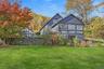 Back of property featuring a yard and a sunroom