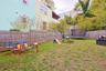 Fenced backyard featuring a trampoline
