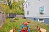 Fenced backyard featuring a trampoline, cooling unit, and view of scattered trees