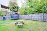 Fenced backyard with a trampoline