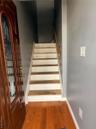 Stairs featuring wood finished floors and baseboards