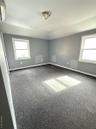Spare room featuring healthy amount of natural light and carpet floors