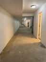 Hall featuring unfinished concrete floors