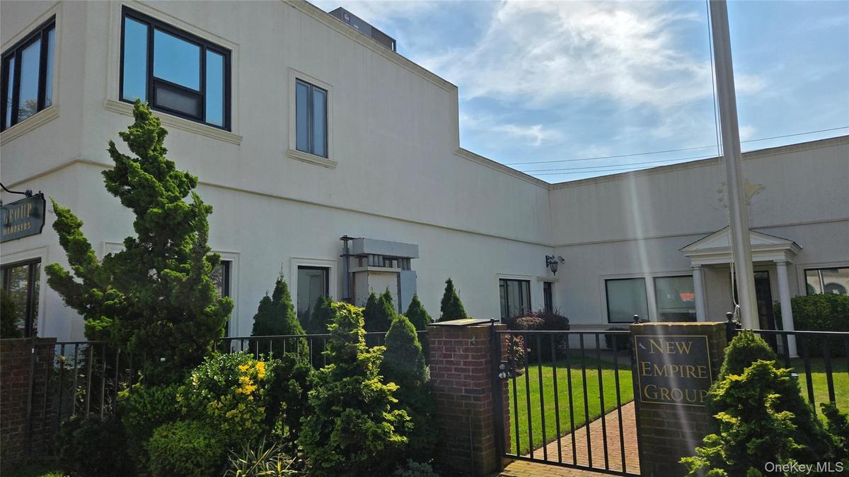 View of building exterior featuring a fenced front yard