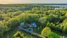 Aerial view at dusk indicating proximity to water and secluded, adjacent acreage