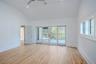 Master Bedroom with sliding doors leading onto private deck overlooking pool and wooded acreage