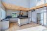Chef's Kitchen with freestanding island, stainless appliances,  granite countertops, recessed lighting and a pantry