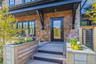 Entrance to property featuring a wrap-around, mahogany deck and built-in planters