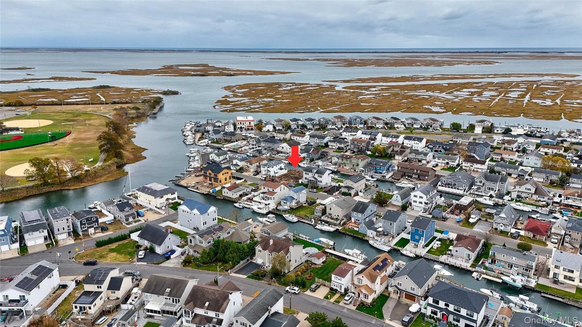 Aerial overview of property's location with nearby suburban area and a nearby body of water