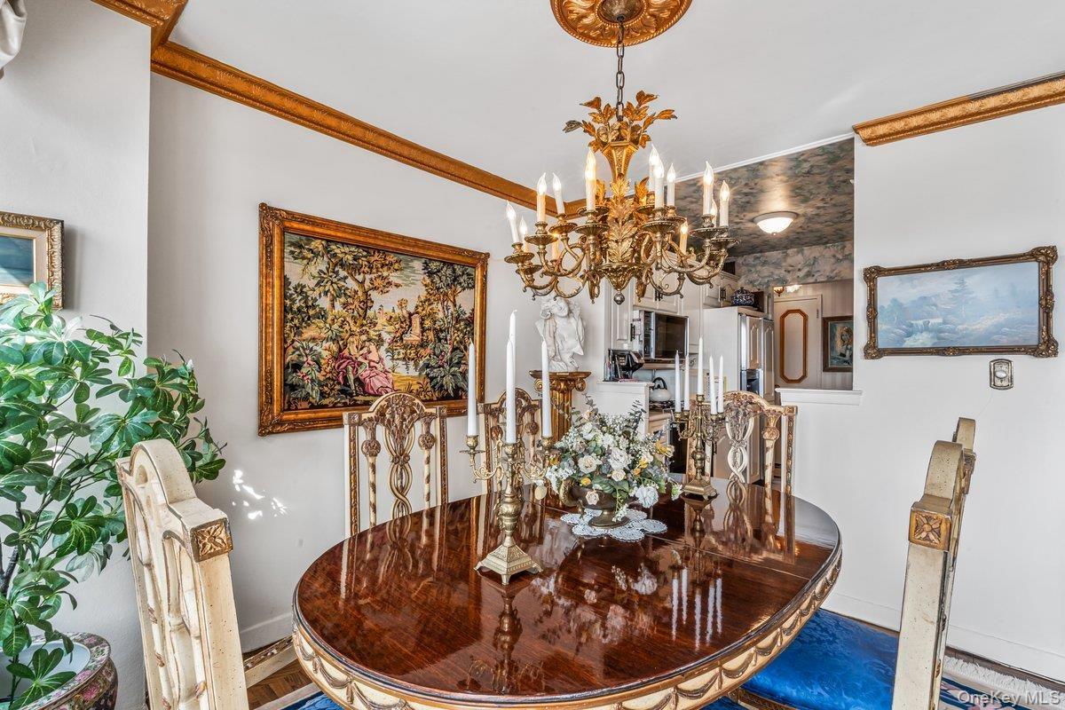 Dining space featuring ornamental molding and a chandelier