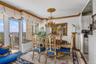 Dining space with ornamental molding and a chandelier