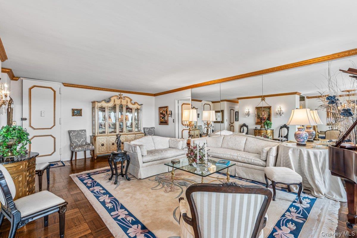 Living room featuring ornamental molding and a chandelier