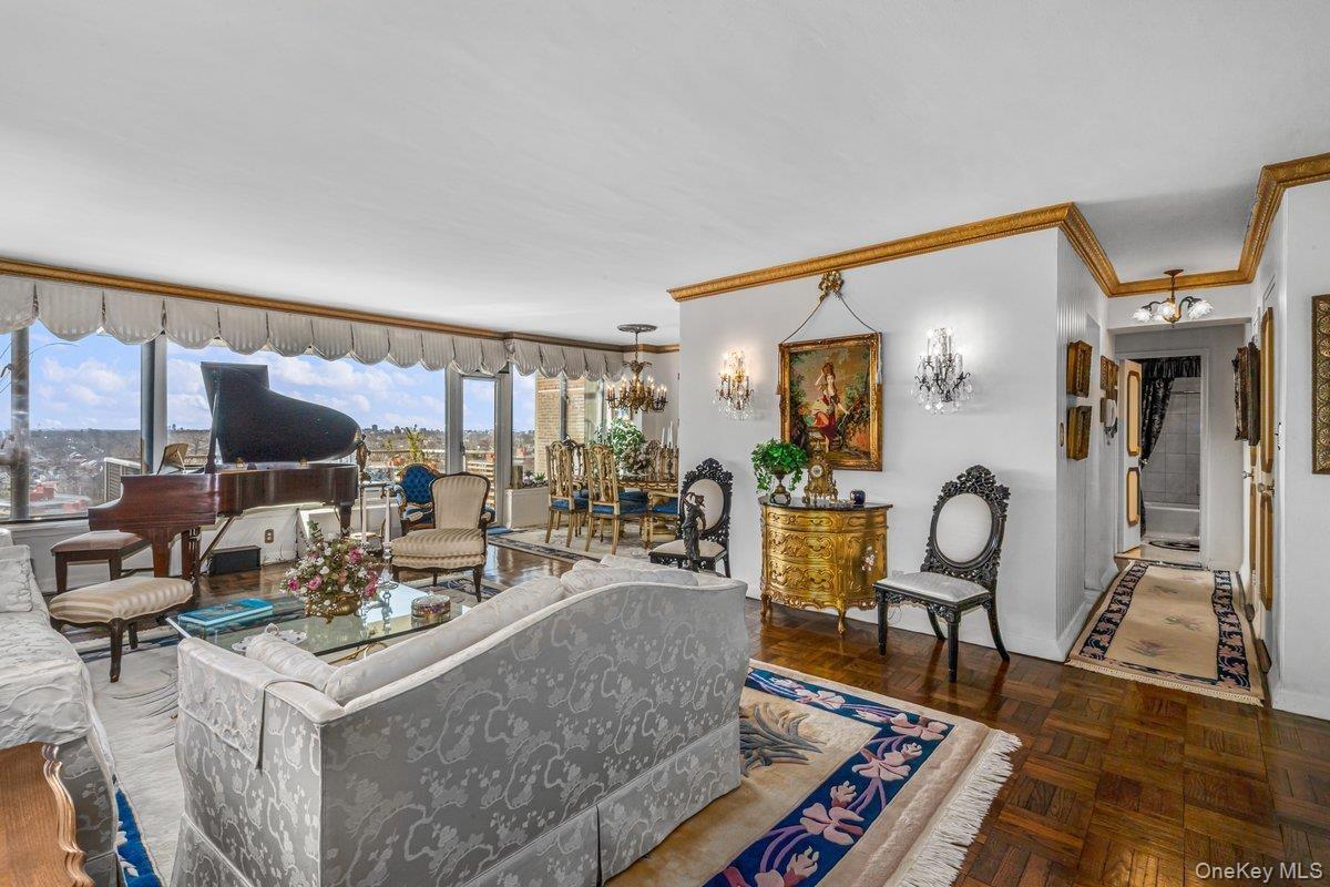 Living area with a chandelier and ornamental molding