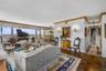 Living area with a chandelier and ornamental molding