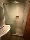 Bathroom featuring vanity, a shower stall, and wood finished floors