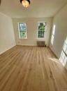 Empty room featuring radiator and light wood-type flooring