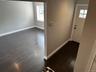 Entryway with baseboards and dark wood-style floors