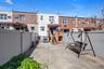 Back of house with a fenced backyard, a residential view, and a patio area