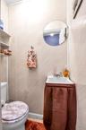Half bath with tile walls and vanity