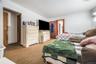 Bedroom with light carpet and radiator heating unit