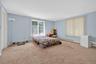 Carpeted bedroom featuring a baseboard radiator