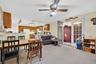 Dining room with light carpet, french doors, and a ceiling fan