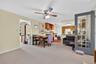 Dining room featuring light carpet and ceiling fan