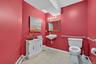 Bathroom with a baseboard heating unit and light tile patterned floors