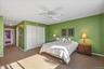 Bedroom featuring attic access, carpet, a closet, and a ceiling fan